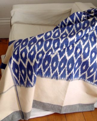 Image of handwoven ikat bedcover in blue and cream