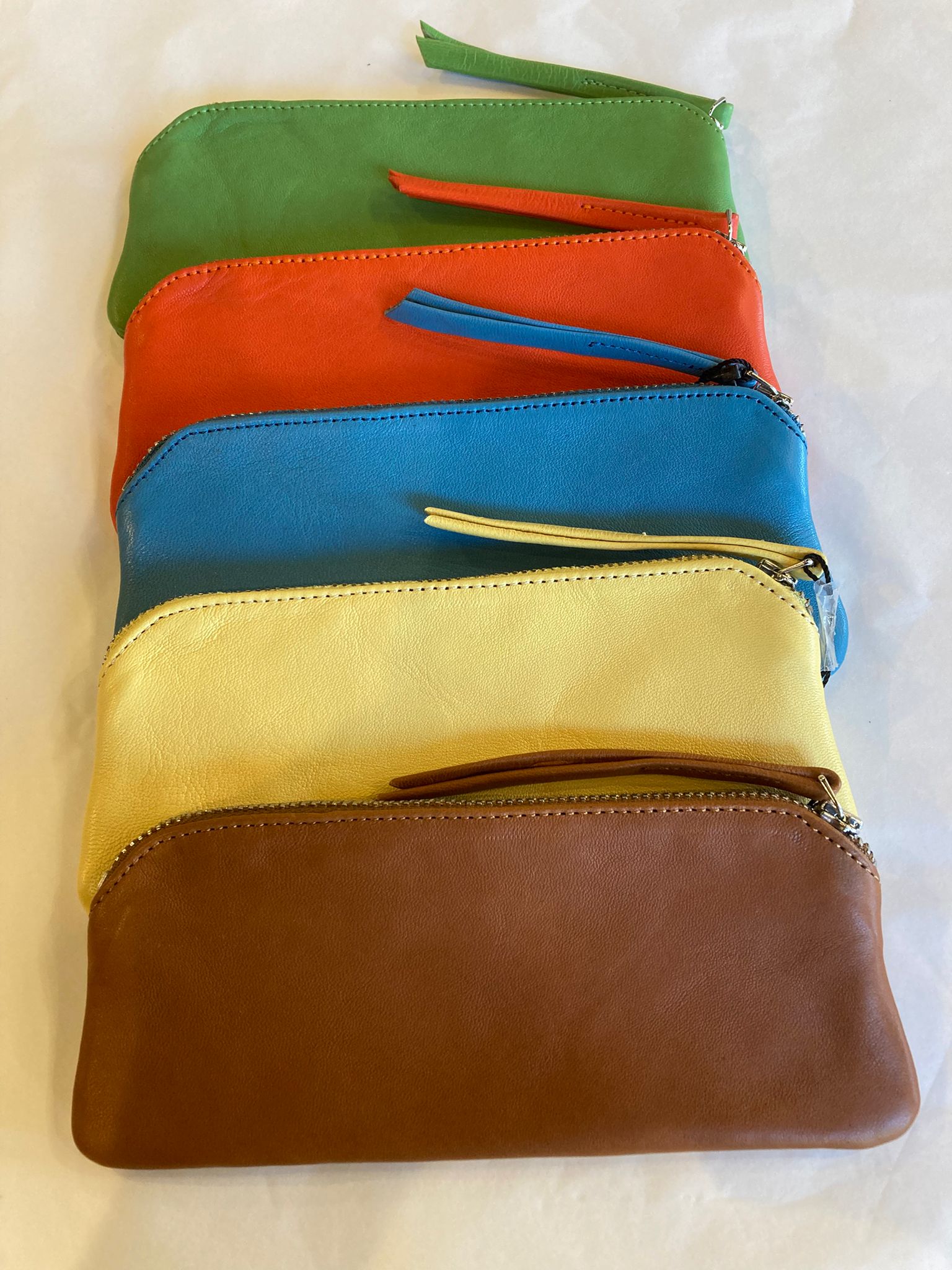 Leather spectacle cases in green, orange, blue, yellow and tan